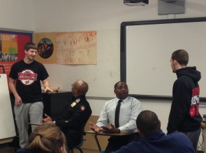 Through role playing scenarios, seniors Ryan Alcott and Joey Marty learn how to handle a traffic stop from Detectives Zeno and Ransom during a session of the Police Interaction Program in Mr. Perry's Facing History course.