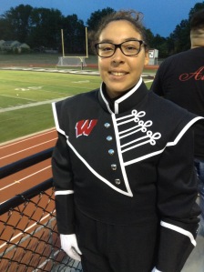 Senior Melody Arvizu poses in her drum major uniform before a game at Priscoe Stadium.