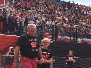 Ben's parents take the field at the spring pep rally. (Credit: Brian O'Halloran)