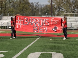 Juniors Adriana Josifoska and Taylor Gautier hold a #BarronsForBen banner during the spring pep rally. The hashtag has been a rallying cry in support of freshman Ben Lepisto's battle against cancer. (Credit: Brian O'Halloran)
